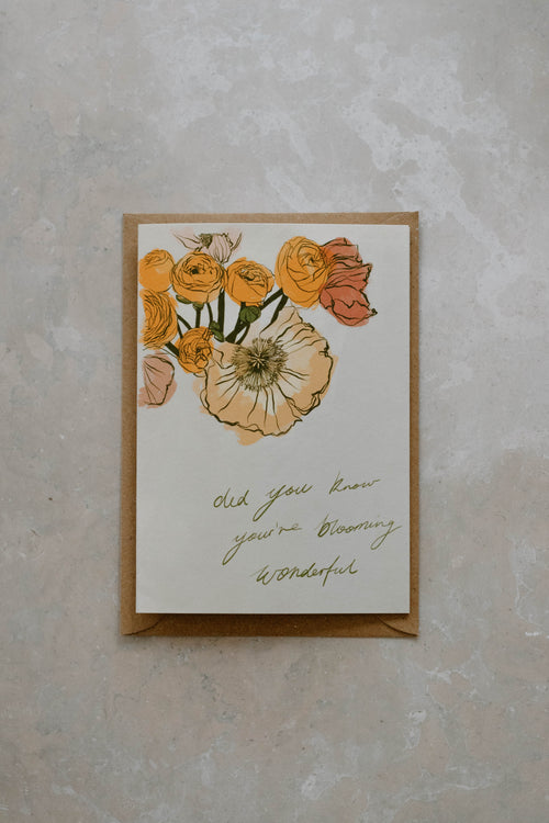 A6 card with floral illustration on top of a Kraft brown envelope