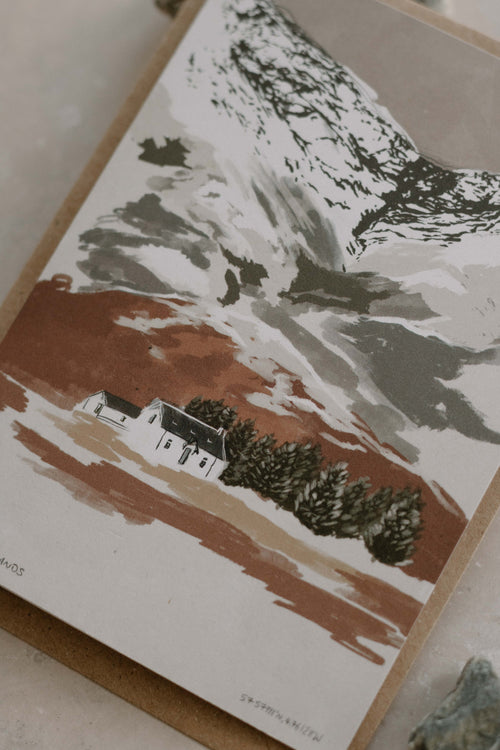 Illustration of a house in a snowy landscape on a card.