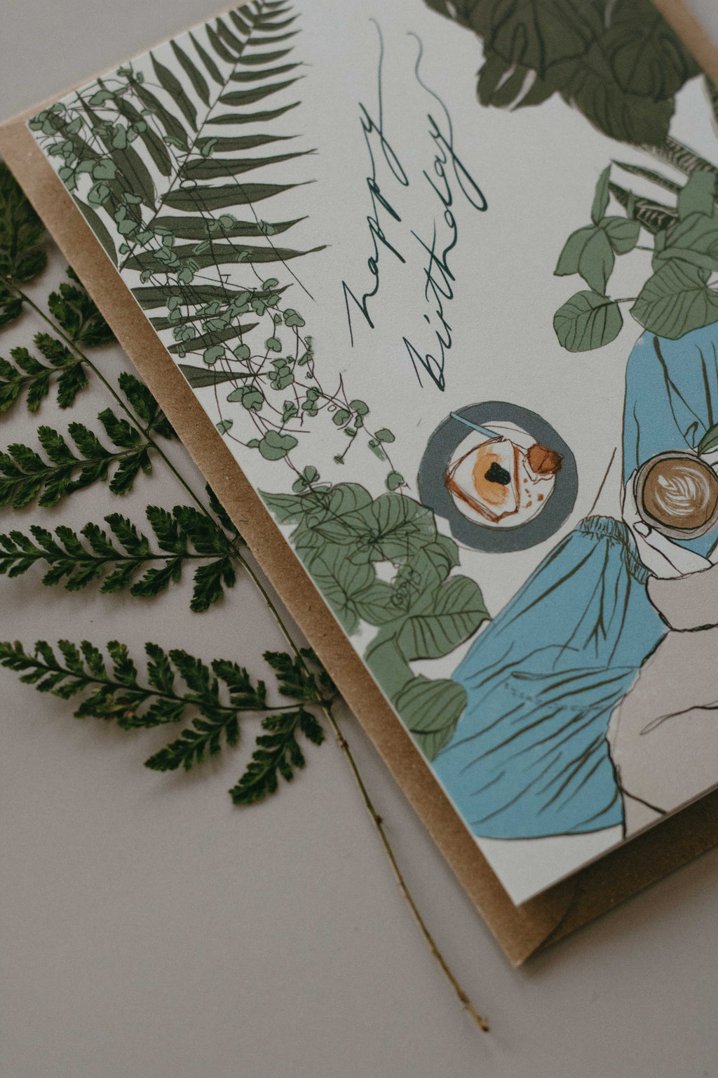 Greeting card with plant-themed design and 'Happy Birthday' text, surrounded by green leaves.