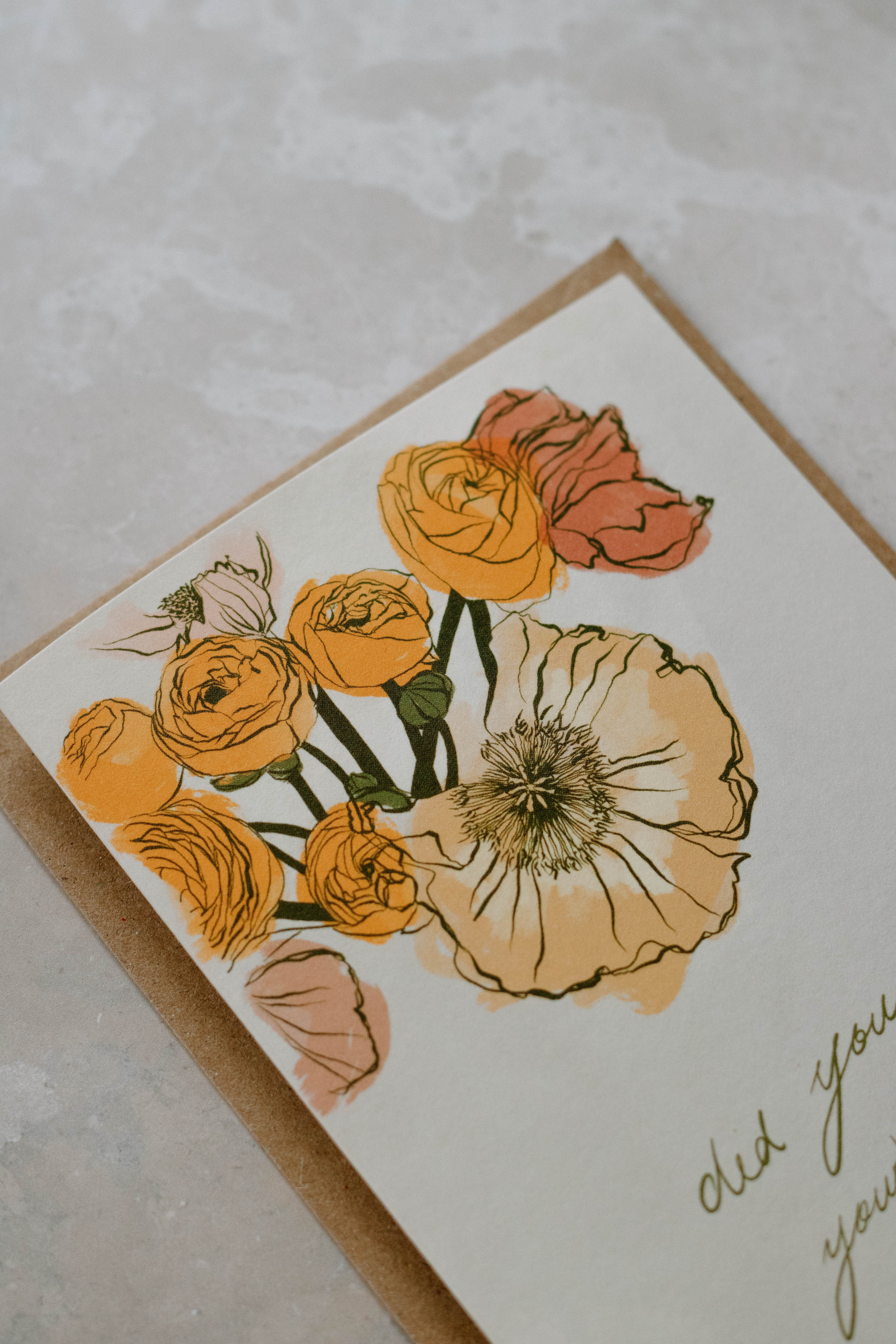 A6 card with floral illustration on top of a Kraft brown envelope