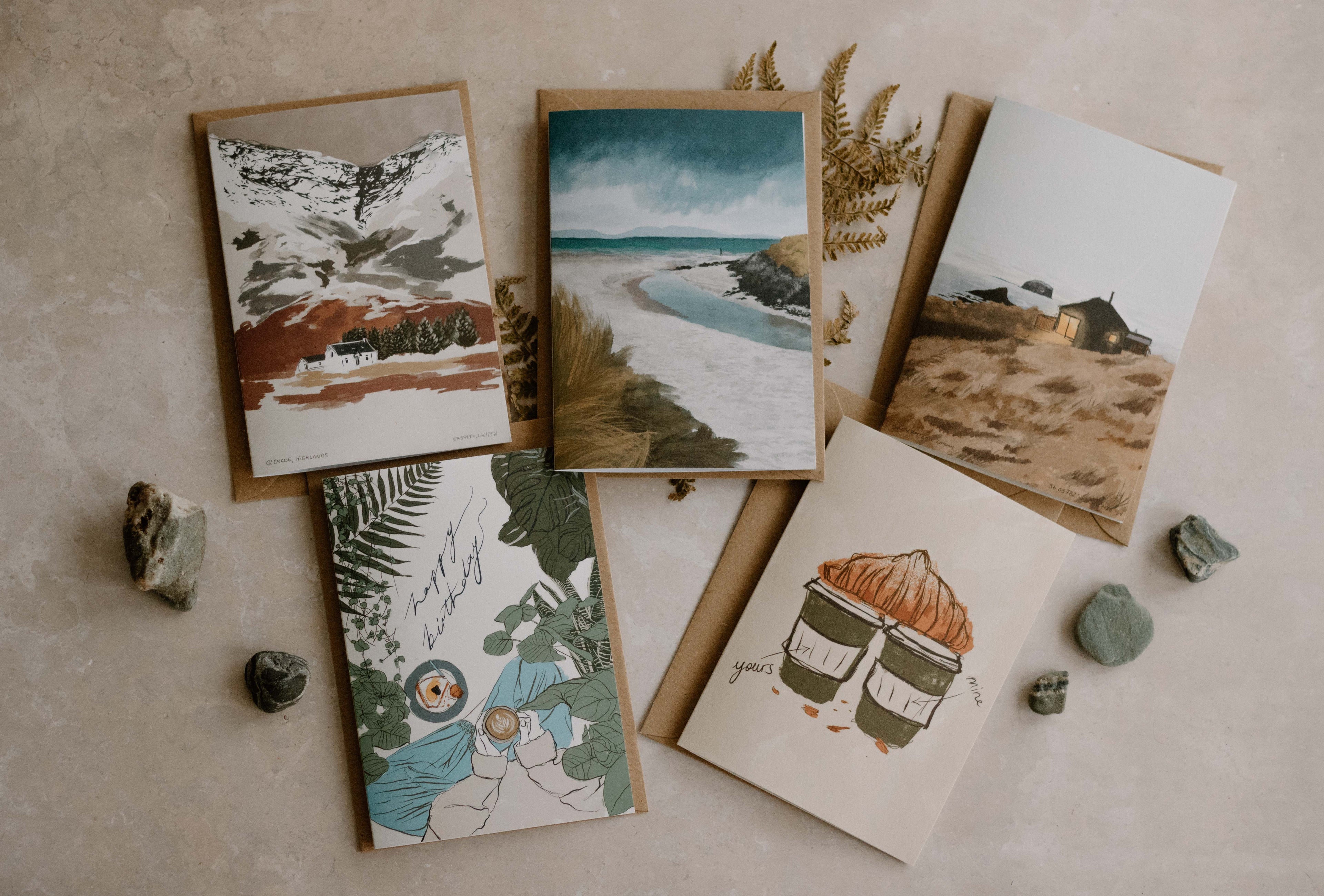 5 greeting cards placed on a natural textured background